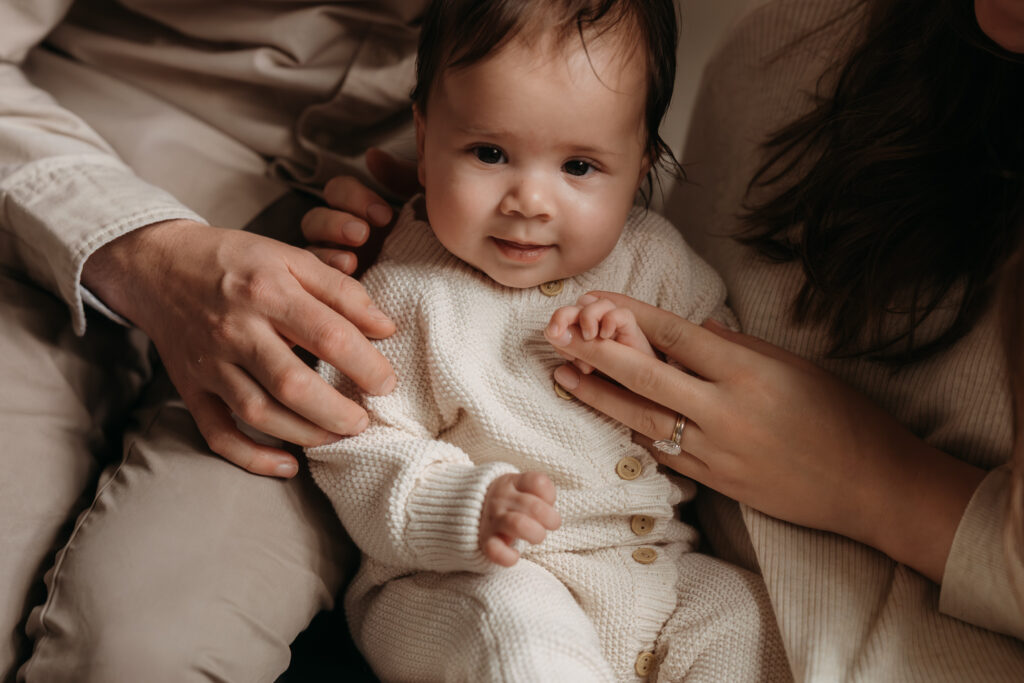 A close-up image of a four month old baby during their photo shoot at home