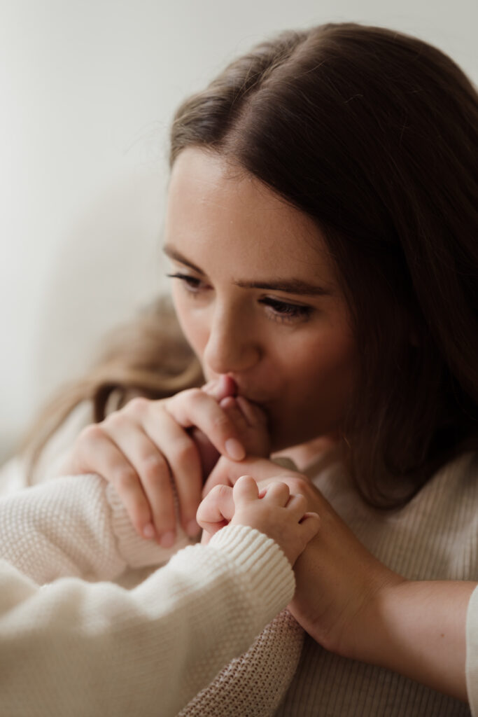 Photo of Mum kissing babies feet at a photo shoot at Home in Hampshire