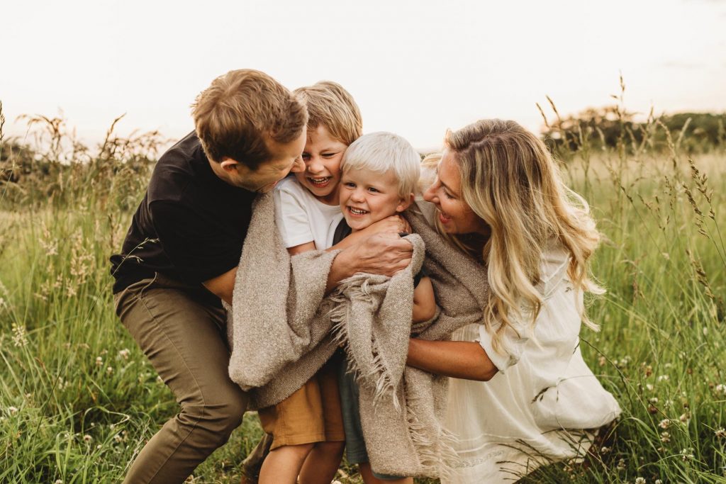 familyplaying i the long grass on their family photo shoot