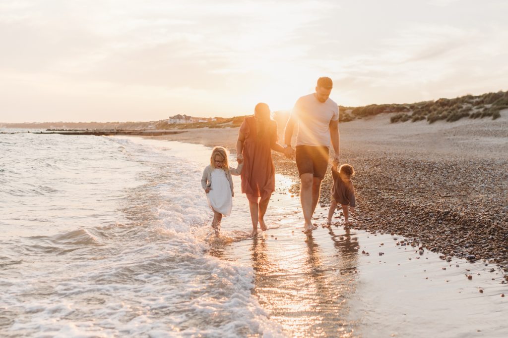 family at sunset on the beach in dorset
