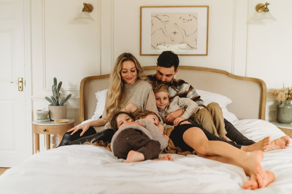 Family enjoying being together in their stylish bedroom 