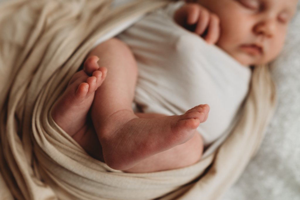 newborn studio photograph of a sleeping baby
