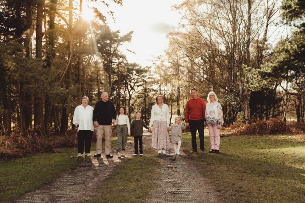 amily strolling through a sunlit pathway, experiencing the charm of the New Forest