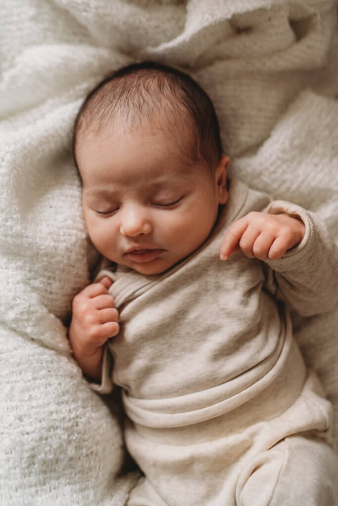 newborn photo of baby sleeping on blanket