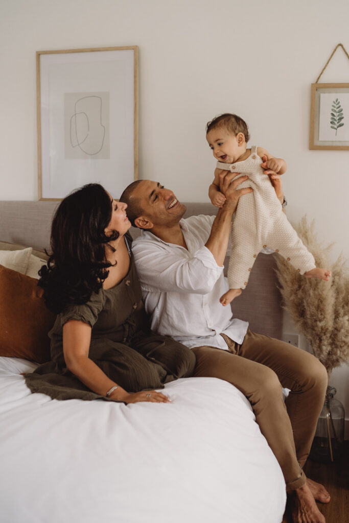 photo of a family at home playing on the bed at home during a photoshoot 